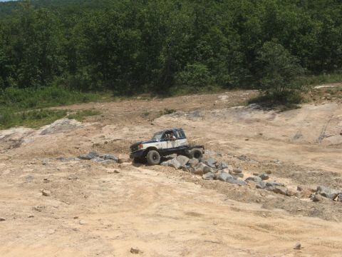 1978 Ford Bronco - A modified off-road vehicle traverses a challenging rocky landscape.