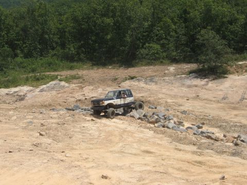1978 Ford Bronco - This modified SUV navigates a challenging rocky course, its off-road capabilities.