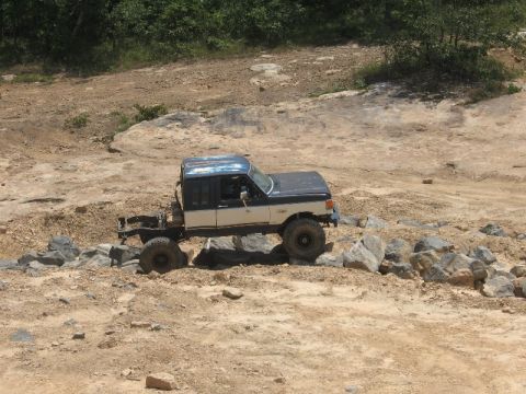 1978 Ford Bronco - Modified pickup truck chassis navigating rocky terrain off-road.