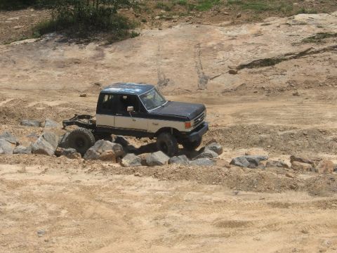1978 Ford Bronco - Modified pickup truck with off-road tires navigating rocky terrain.