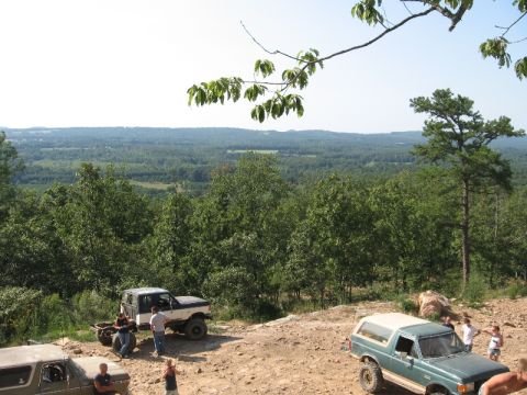 1978 Ford Bronco - A group of people stand around several off-road vehicles at a scenic overlook.