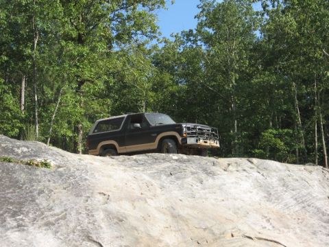 1978 Ford Bronco - This SUV navigates a rocky terrain with its front grille missing.