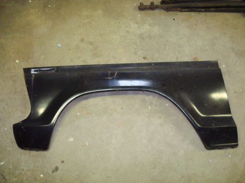 1995 Ford Bronco - Black fender panel shown on a concrete surface.