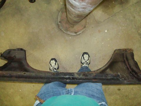 1995 Ford Bronco - A dark metal part is shown from a first-person perspective with feet visible.