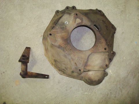1995 Ford Bronco - Transmission bell housing and linkage part shown on a concrete surface.