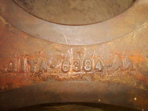 1995 Ford Bronco - A close-up view of a rusty metal part with stamped numbers.