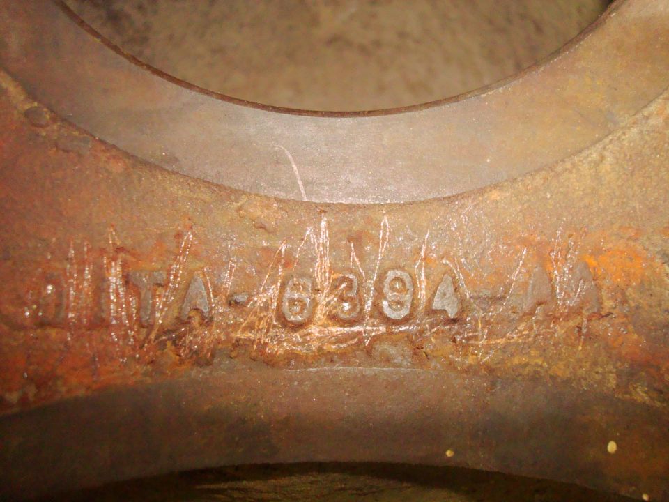 Rusty metal part with stamped numbers 'A-63/94'