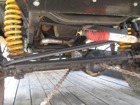 1978 Ford Bronco - Close-up of vehicle undercarriage, focusing on suspension and drivetrain parts.