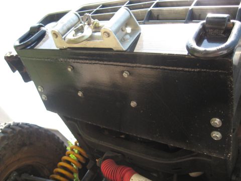 1978 Ford Bronco - Close-up of a vehicle's rear bumper, showing tow hooks and a winch roller assembly.