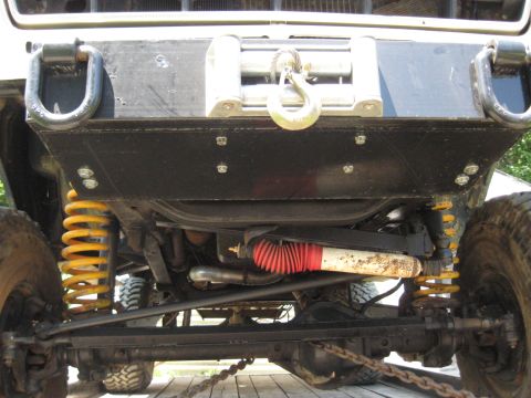 1978 Ford Bronco - Underside view of a 1978 Ford Bronco, showing its front suspension, winch, and off-road modifications.