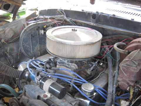 1978 Ford Bronco - The engine compartment is visible, an air filter, distributor, and spark plug wires.