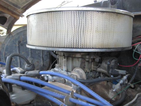 1978 Ford Bronco - Close-up view of a vehicle's engine, focusing on the carburetor and air filter assembly.