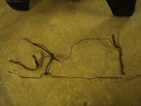 1995 Ford Bronco - Brake lines laid out on a concrete surface, likely for replacement or repair.