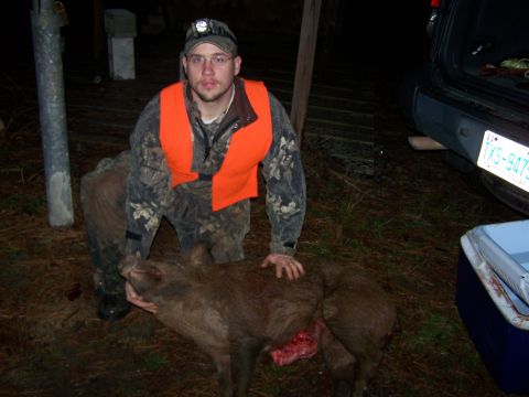 1982 Ford E350 - A hunter poses with two wild boars after a successful hunt.