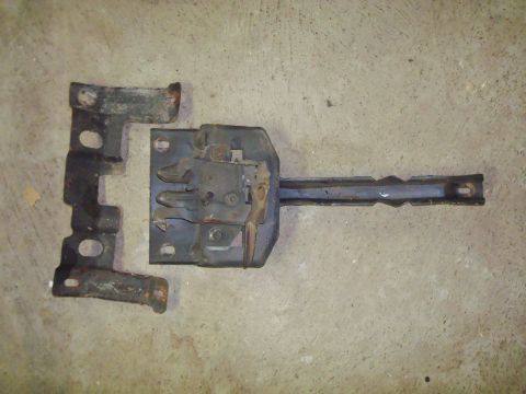 1995 Ford Bronco - This photo shows a detached hood latch mechanism and its corresponding striker plate, likely for repair or replacement.