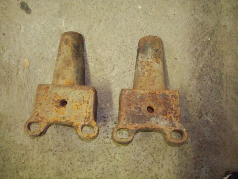 1995 Ford Bronco - Two rusty metal parts are shown against a concrete background.