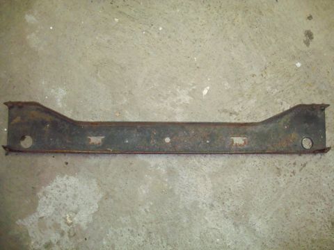 1995 Ford Bronco - This is a rusted metal bracket with several holes and rectangular cutouts, lying on a concrete surface.