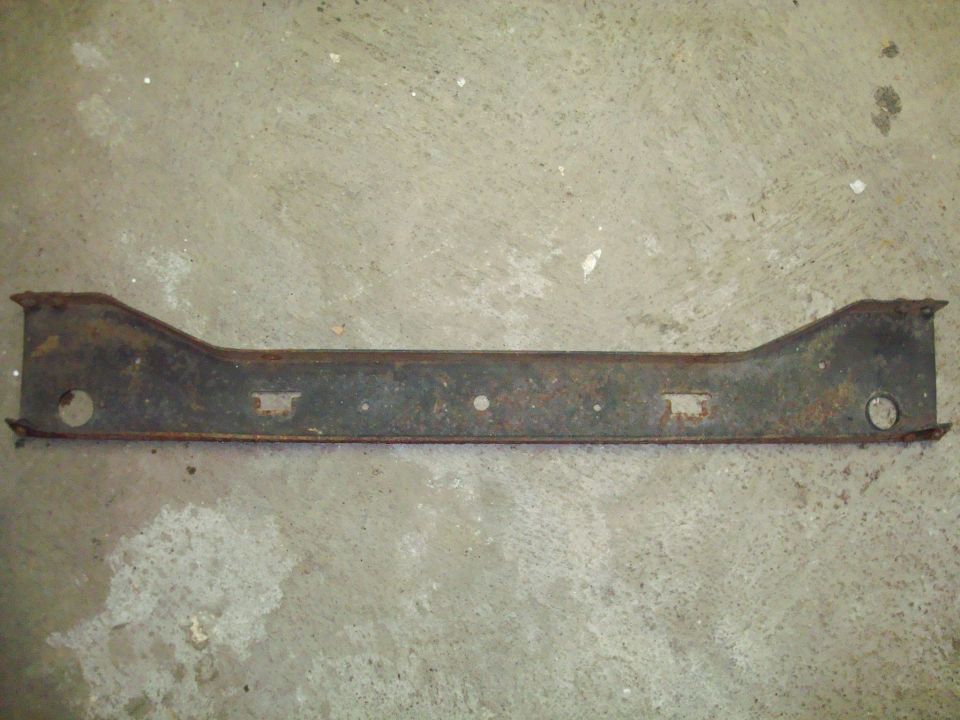 rusted metal bracket with holes and rectangular cutouts