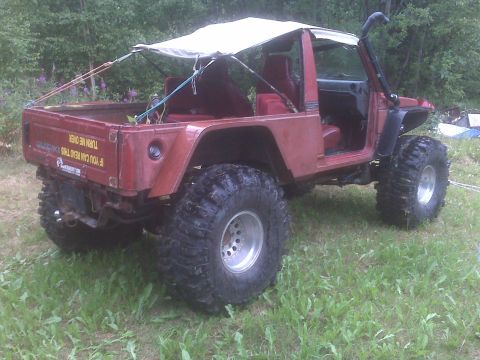 1987 Suzuki Samurai - This vehicle has a custom canopy and a snorkel, suggesting it's built for off-road use.