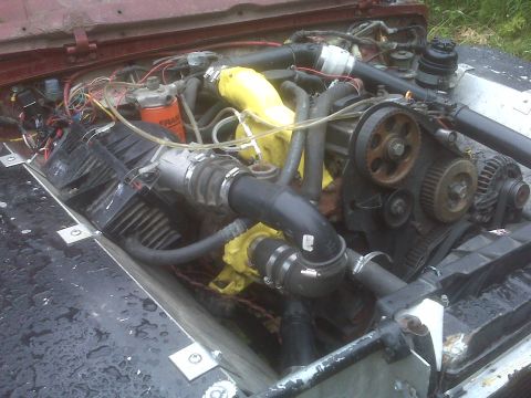 1987 Suzuki Samurai - The engine bay of a vehicle is shown with various mechanical parts and wiring.