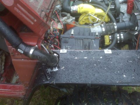 1987 Suzuki Samurai - The engine bay of a vehicle features a snorkel intake and a prominent yellow turbocharger.