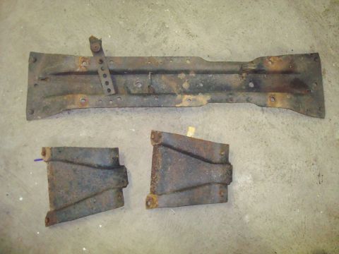 1995 Ford Bronco - Set of three rusted metal parts, likely from a vehicle's undercarriage or frame.