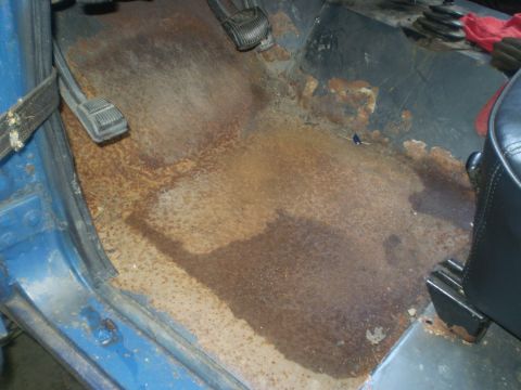 1979 Ford Bronco - The interior floor of the vehicle shows significant rust and water damage, indicating potential structural issues.