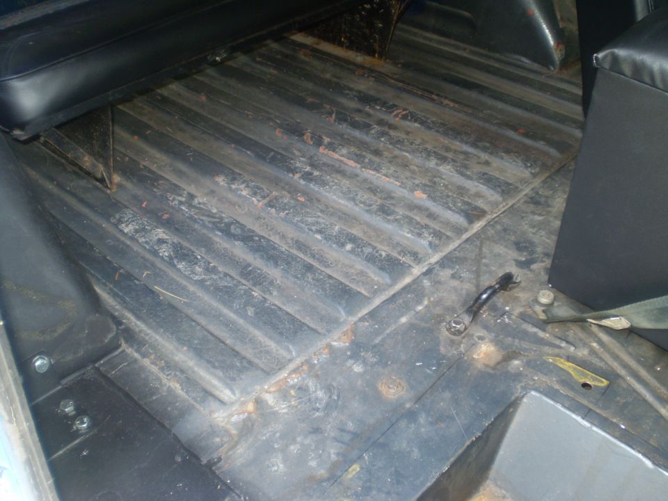 Interior floor with ribbed metal and black seats