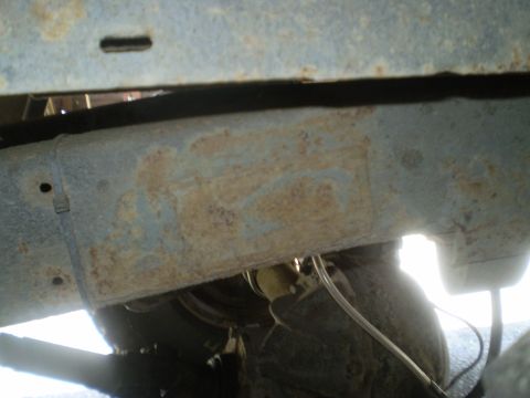 1979 Ford Bronco - Close-up view of a heavily rusted vehicle frame, showing signs of wear and tear.