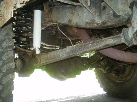 1979 Ford Bronco - Close-up view of the undercarriage, showing suspension components and exhaust pipes.
