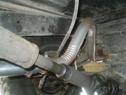 1979 Ford Bronco - Close-up view of the undercarriage, showing the driveshaft and exhaust pipework.