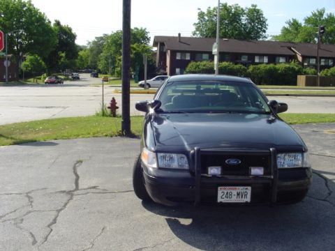 2000 Ford Crown Victoria - Front view of a black 2000 Ford Crown Victoria Police Interceptor with a push bar and Wisconsin license plate.