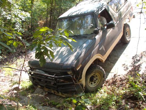 1983 Ford Bronco - At the bottom, my low approach angle snagged this rock, but the bumper was stronger - the rock broke & I continued out. Note the trees in t…
