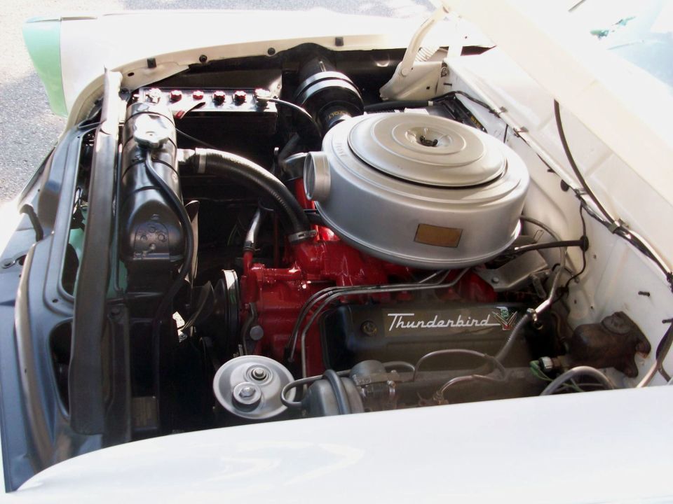 Vintage Ford Thunderbird V8 engine bay with red block and chrome air cleaner