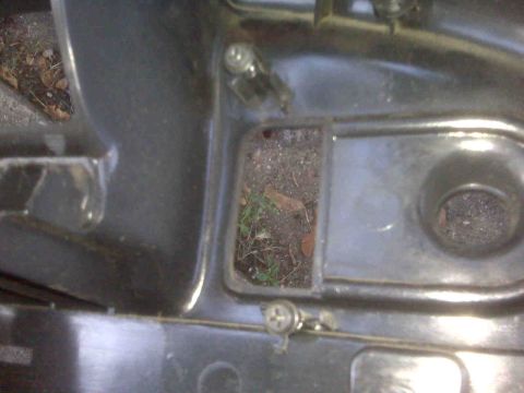 1995 Ford Bronco - Debris has collected in a crevice of the vehicle's interior, near a mounting screw.