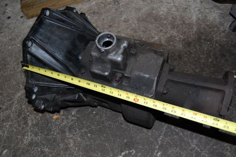 1994 Ford Bronco - Measuring tape on a transmission housing, Supermotors.net logo in corner.