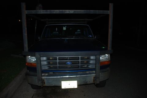 1994 Ford F-250 - Front view of a blue Ford truck equipped with a custom metal rack, likely a 1992 model based on its grille design.