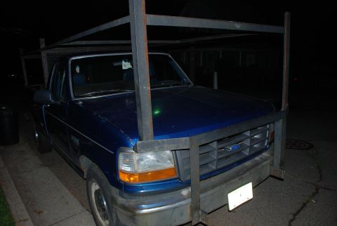 1994 Ford F-250 - This blue 1994 Ford F-250 is equipped with a heavy-duty metal rack extending over the cab and bed.
