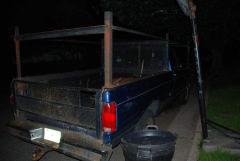 1994 Ford F-250 - Rear view of a blue 1994 Ford F-250 pickup truck equipped with a metal rack system.