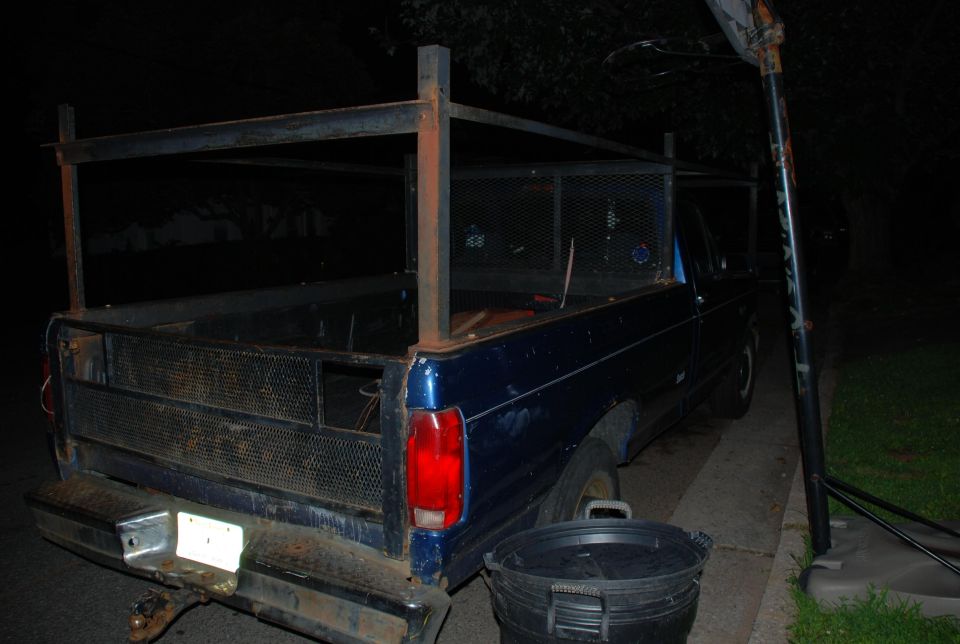 1994 Ford F-250 pickup truck with a custom metal rack in the bed, viewed from the rear
