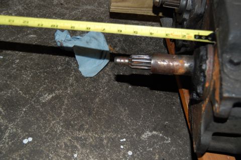 1994 Ford Bronco - A close-up view of an axle shaft being measured with a tape measure.