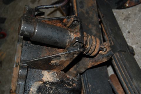 1994 Ford Bronco - Close-up of a rusty brake caliper assembly, likely from an older vehicle.