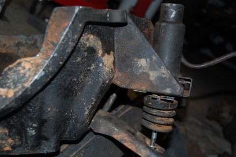 1994 Ford Bronco - Close-up of a rusty suspension component, likely from a vehicle's axle assembly.