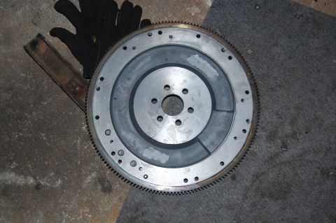 1994 Ford Bronco - A metal flywheel, likely from a vehicle's transmission, is shown on the ground.