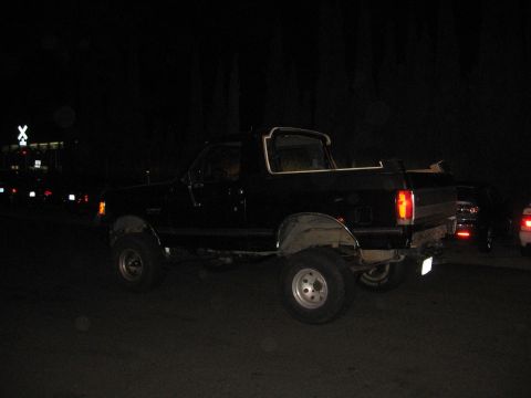 1989 Ford Bronco - This black 1989 Ford Bronco features a removable top and is seen from the rear quarter angle.