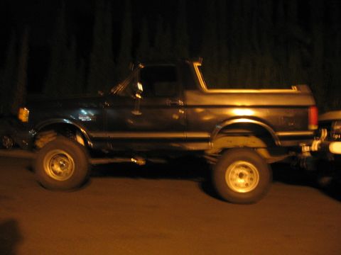 1989 Ford Bronco - Side view of a dark 1989 Ford Bronco, captured at night.