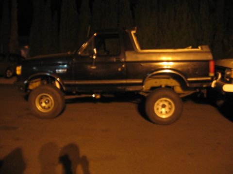 1989 Ford Bronco - This 1989 Ford Bronco is seen from the side under artificial lighting.