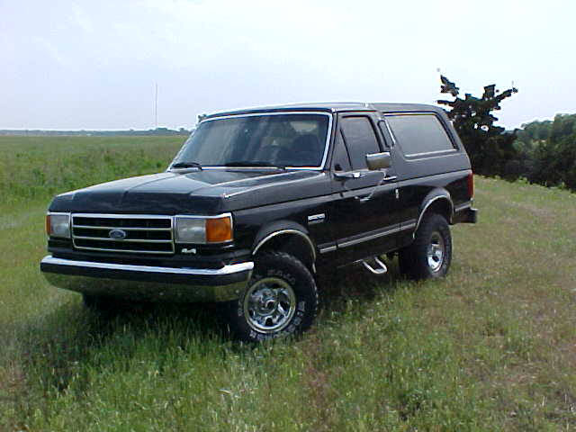 1989 Ford Bronco parked in a grassy field