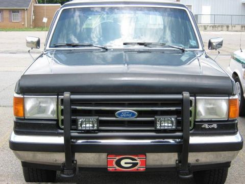 1990 Ford Bronco - Front view of a 1990 Ford Bronco, a bull bar, auxiliary lights, and the iconic Ford grille.
