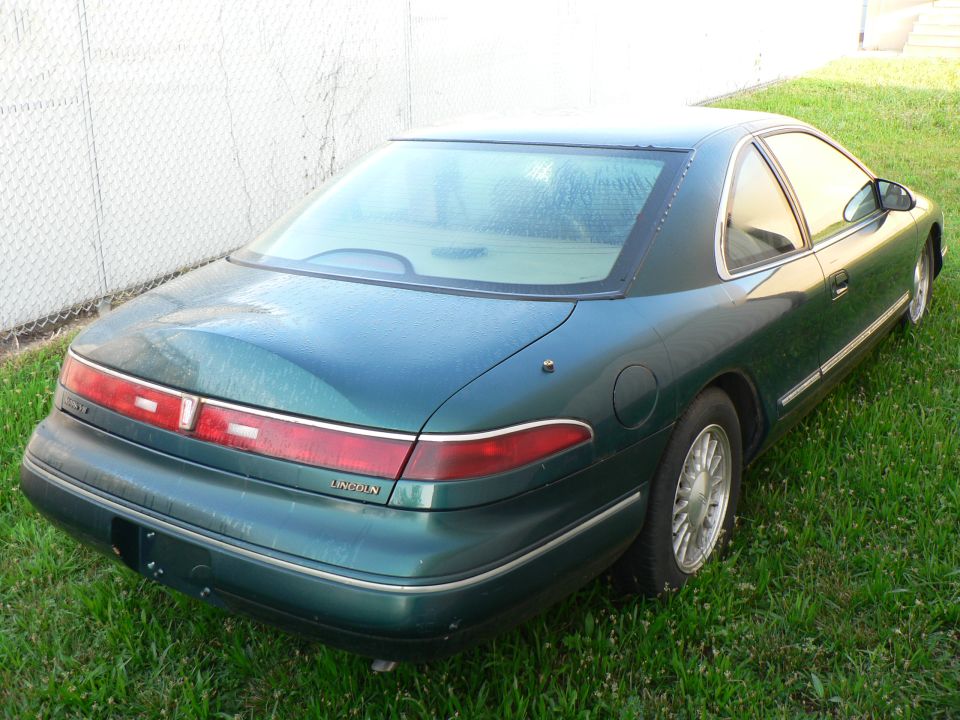 Green Lincoln coupe rear view. Lincoln badging visible on rear
